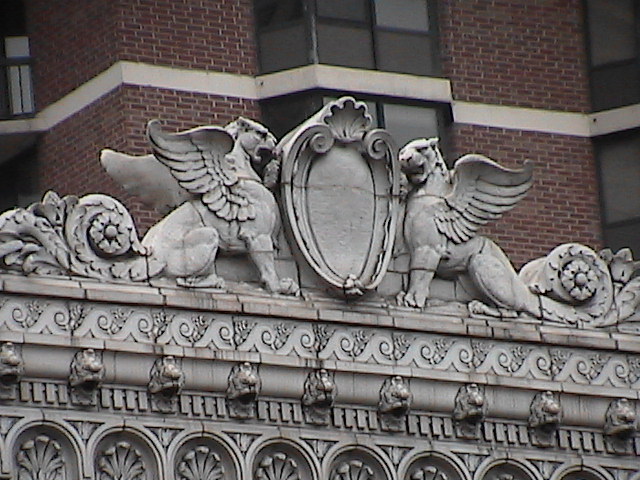 the emblem on top of an old stone building