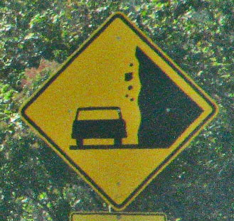 a warning sign indicating to avoid falling on the road