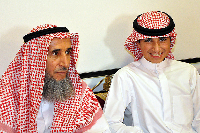 a couple of men in dress clothes standing next to each other