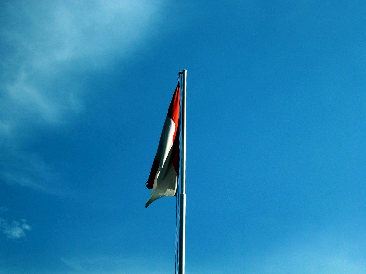 the red, white and blue flag on top of a pole