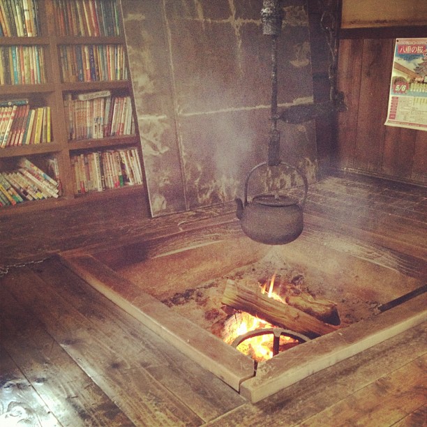 an old wood stove in a room with some books