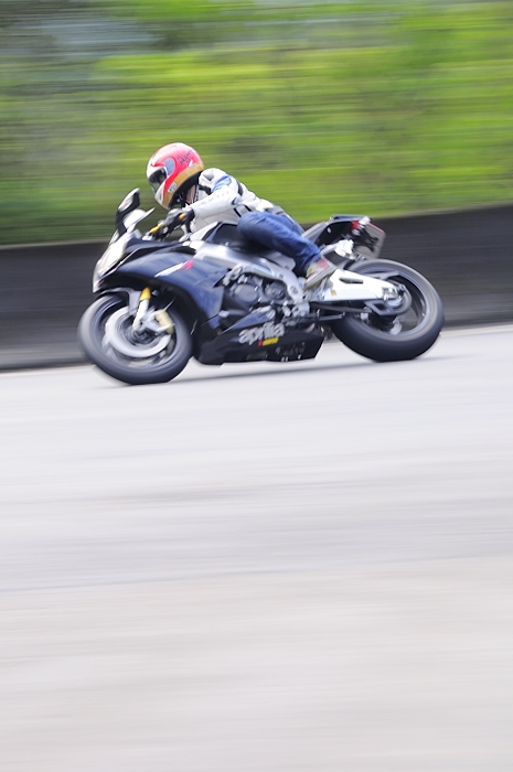 a motorcyclist in motion making a sharp turn
