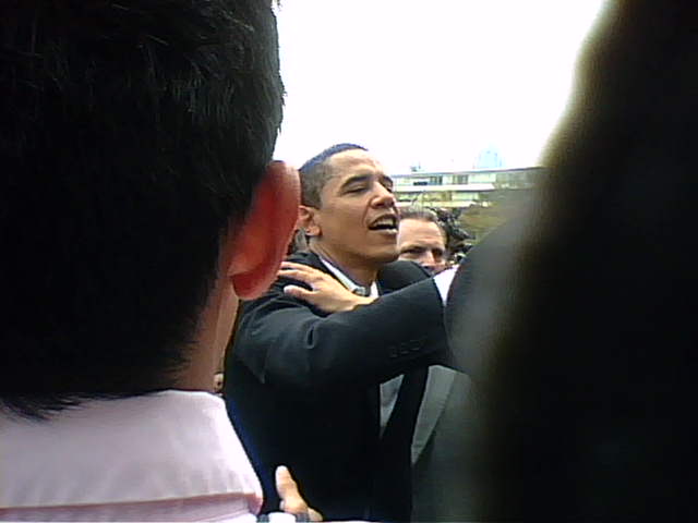 obama is emcing a man in the middle of an audience