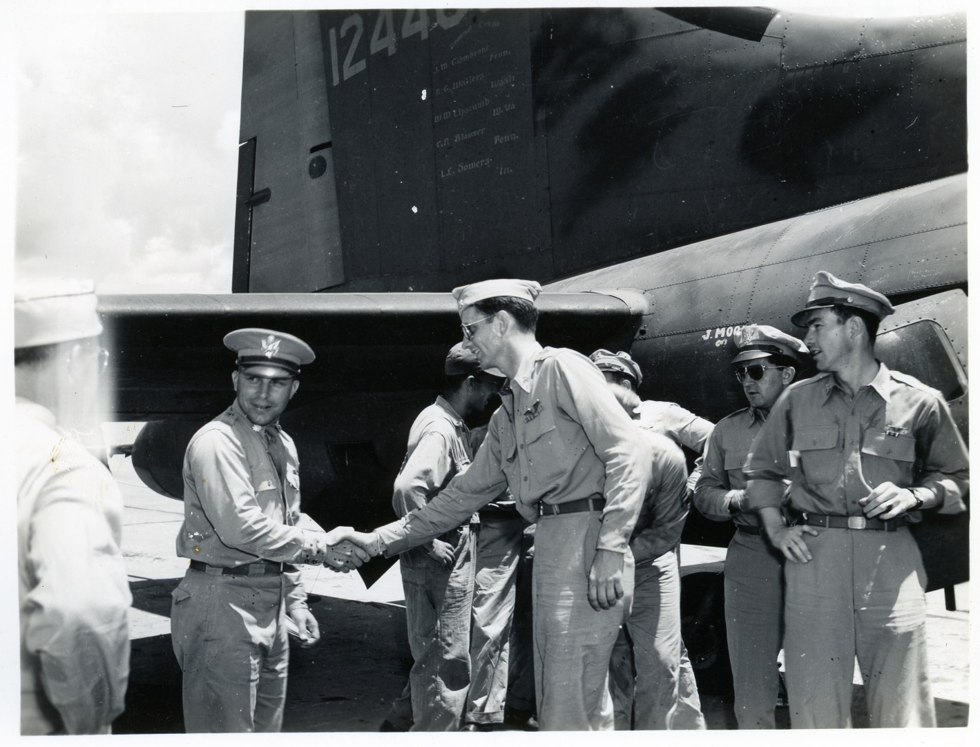 a black and white po of three men shaking hands