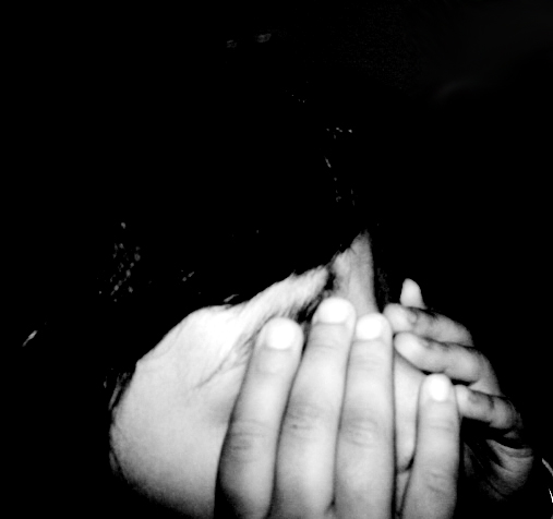 a woman is covering her face with her hands