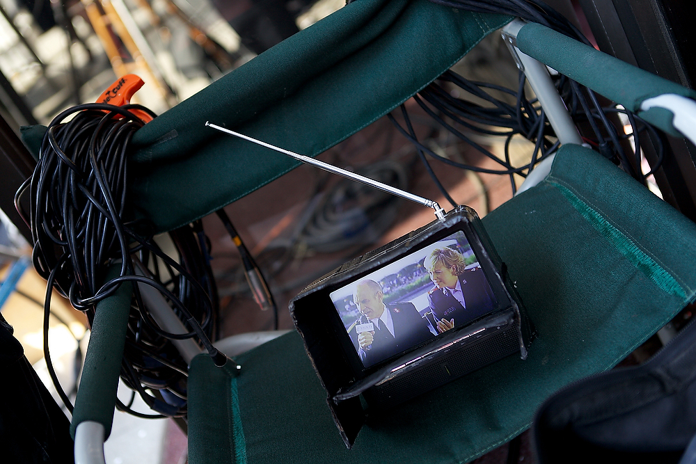 a small screen sitting next to wires and electrical cords