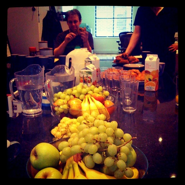 a bunch of fruit is on a table next to another bunch