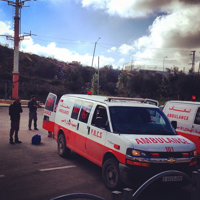 three ambulances are parked on the side of the road