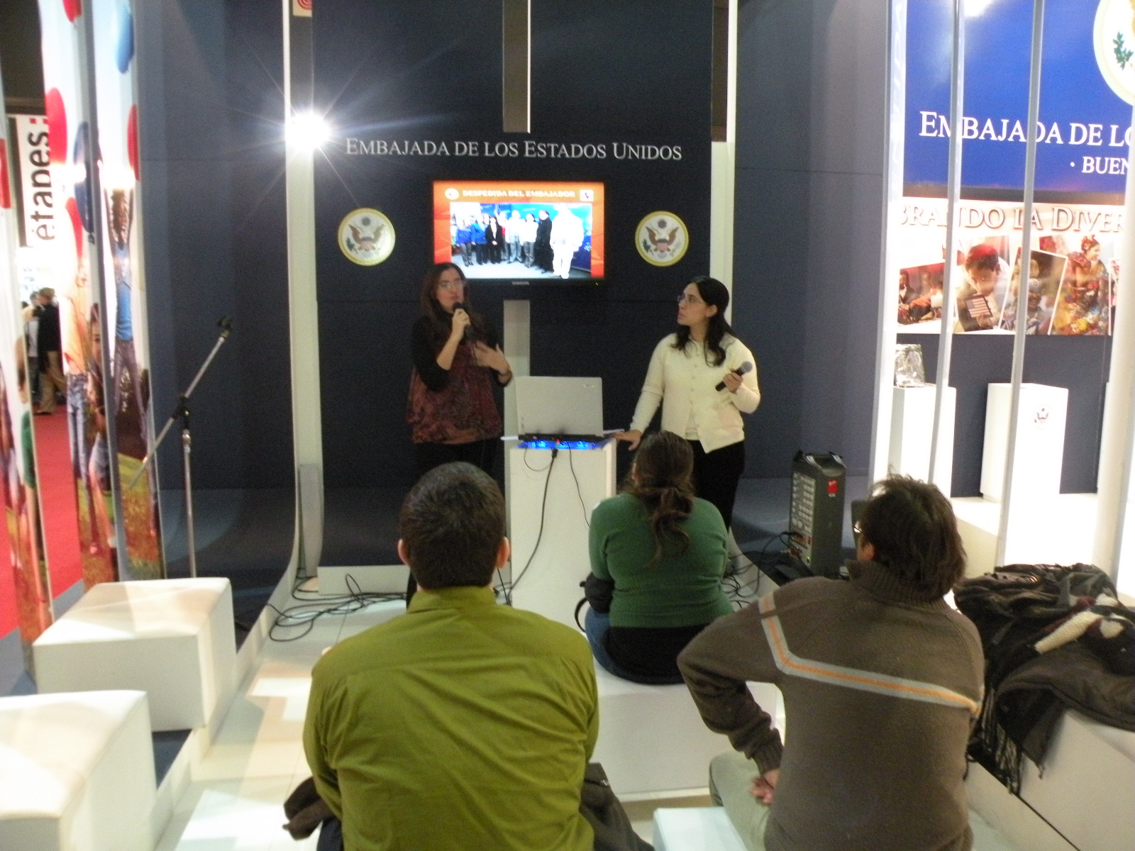 three people sitting in front of a television on a set