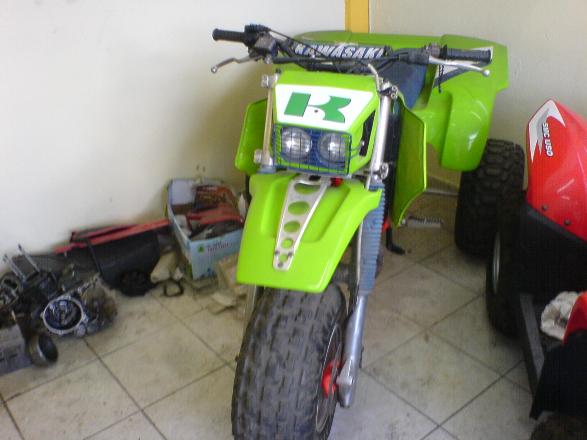 the front view of a green and black dirt bike