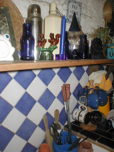 many bowls, spoons and other kitchen items on the counter