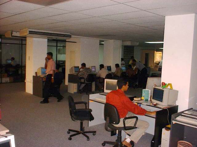 a large open office filled with people and computers