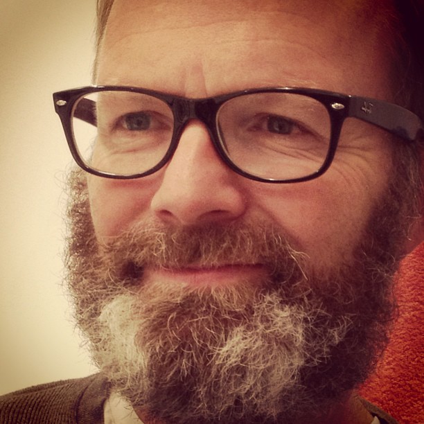 this is a close up picture of a man with a beard and glasses