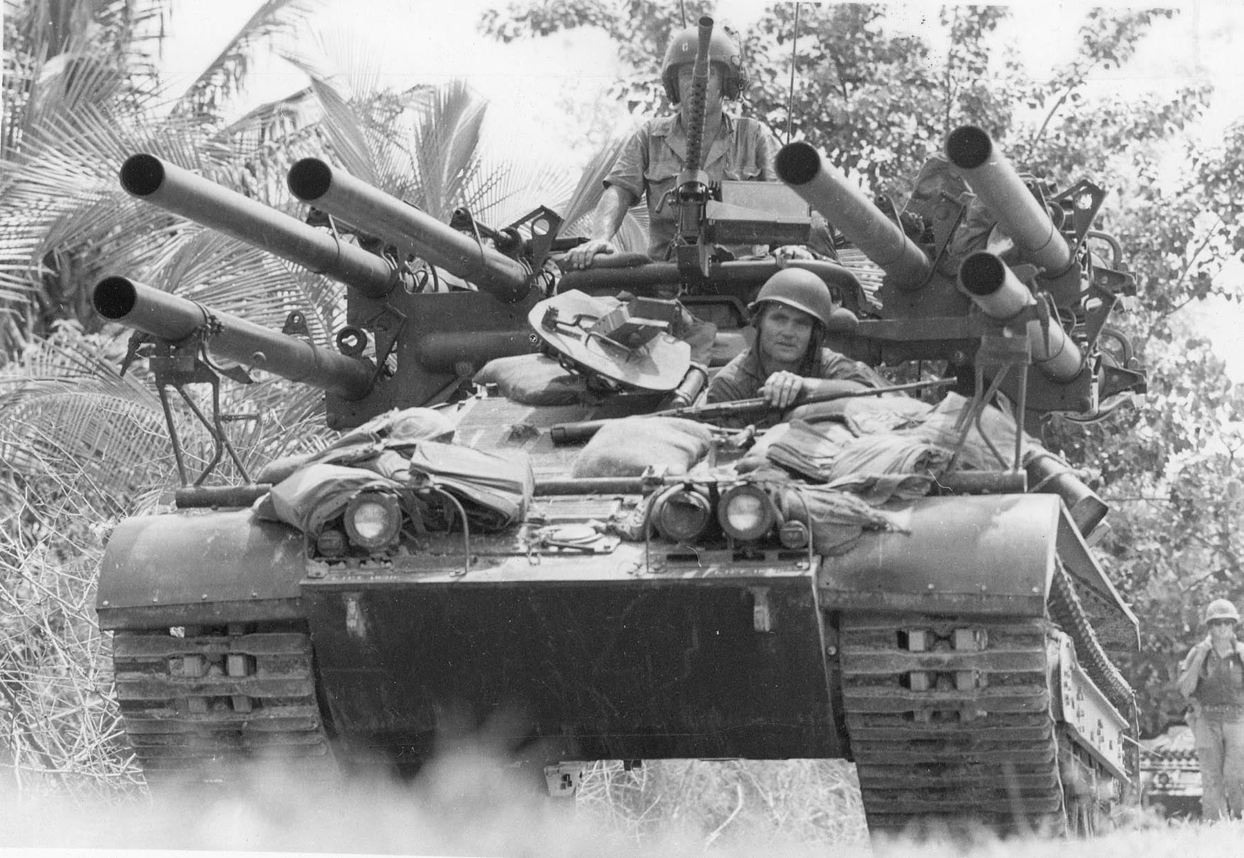 soldiers resting in tanks with guns pointing at them