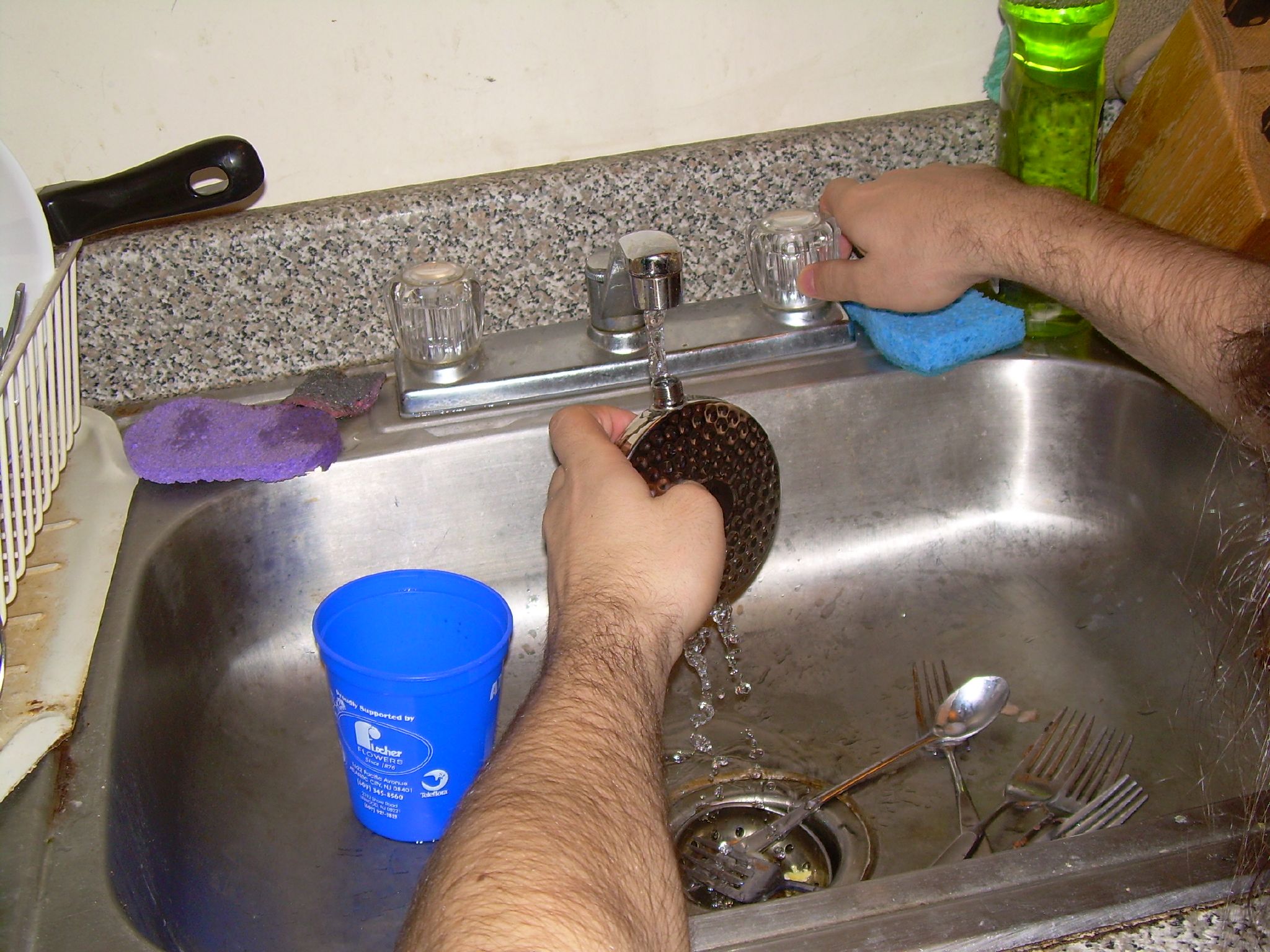 a person is washing dishes in a sink