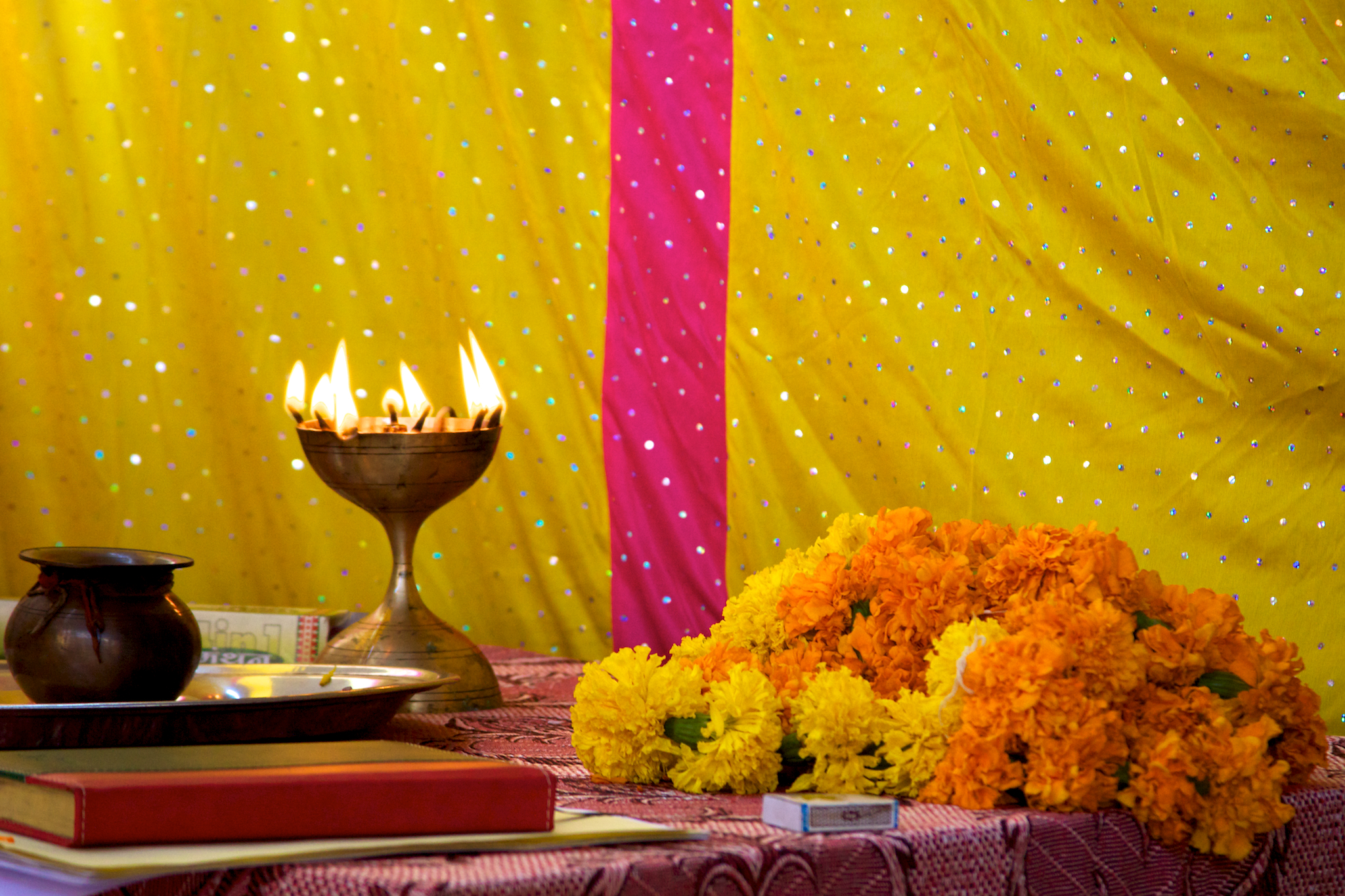 colorful decorations sitting on a table surrounded by books and vases