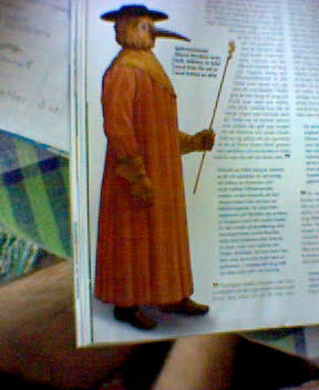 a picture of a man standing up in an orange robe