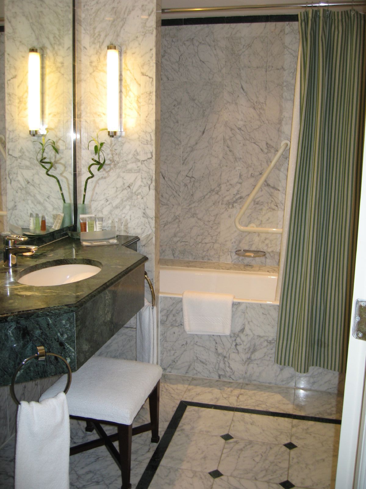 bathroom area with counter, towel rack and mirror