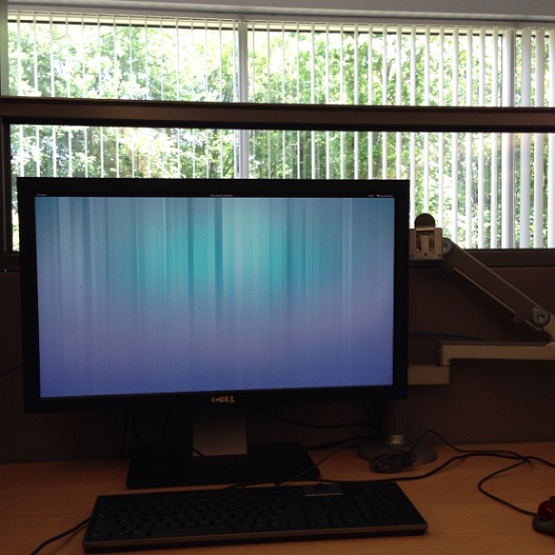 a large computer screen is on top of a desk