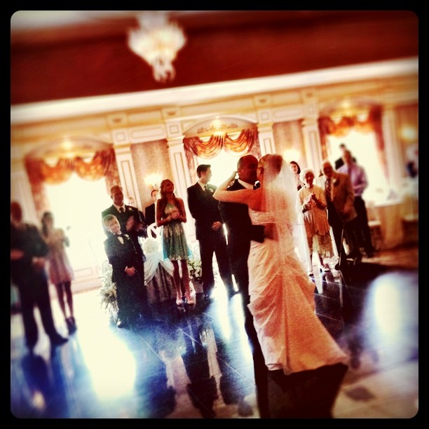 bride and groom dancing in an elegant ballroom