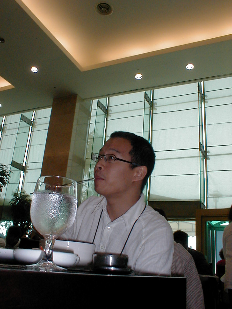 a person sitting at a table with a glass of wine