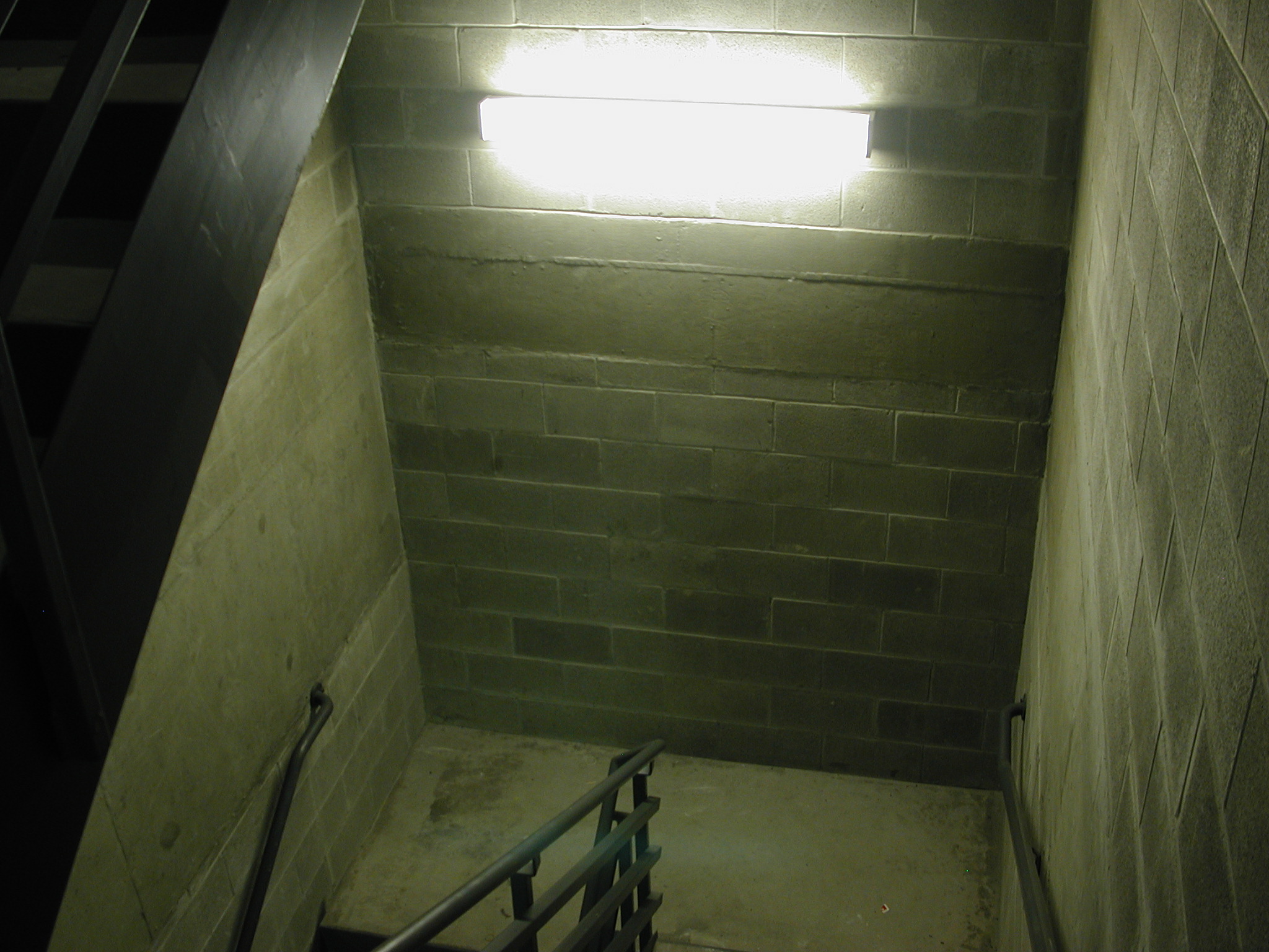 an open stairway at night, with bright light from above