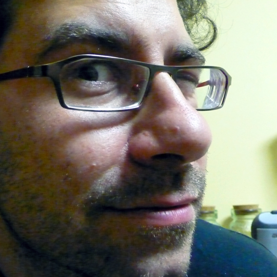 a close up s of a man with a beard and glasses