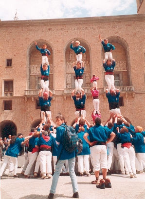 a group of men are balancing on a wall