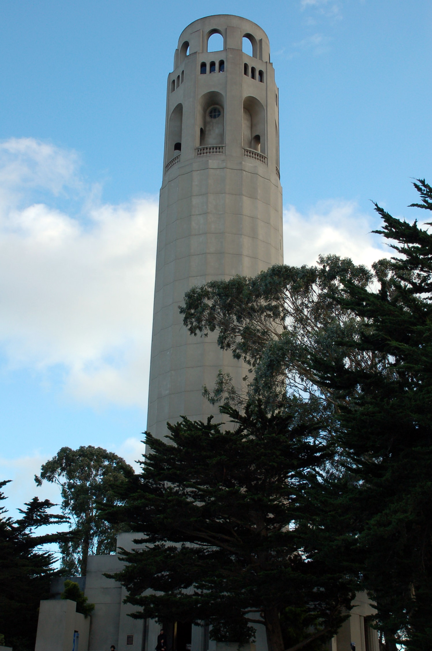 a tall white clock tower with two bells