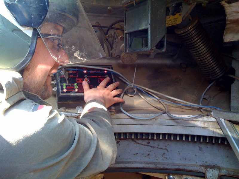 the man is fixing a car stereo in a vehicle