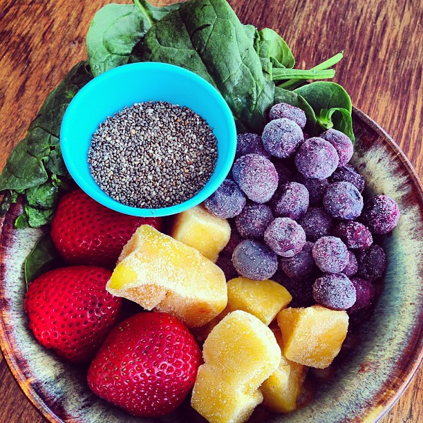 colorful fruits and vegetables in a bowl are shown