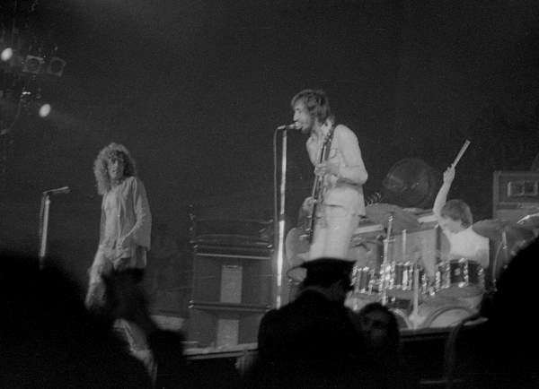 the rolling stones are seen performing on stage at a concert