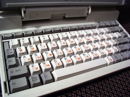 a keyboard sitting on top of a computer