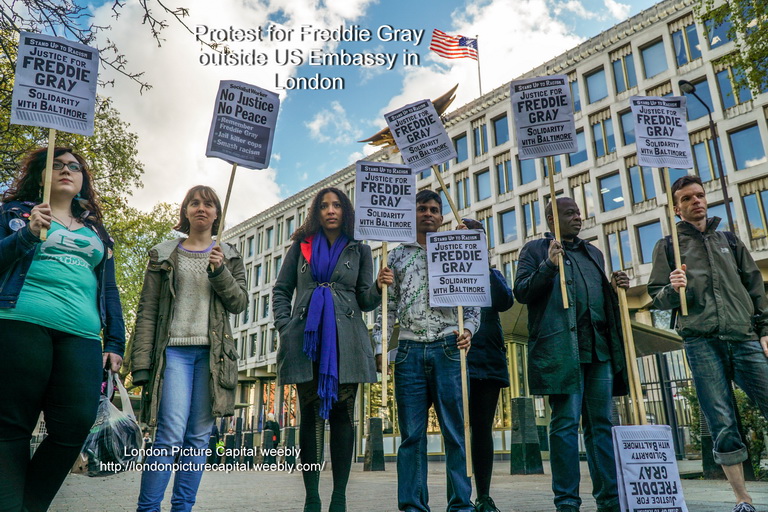 a group of people holding signs standing next to each other