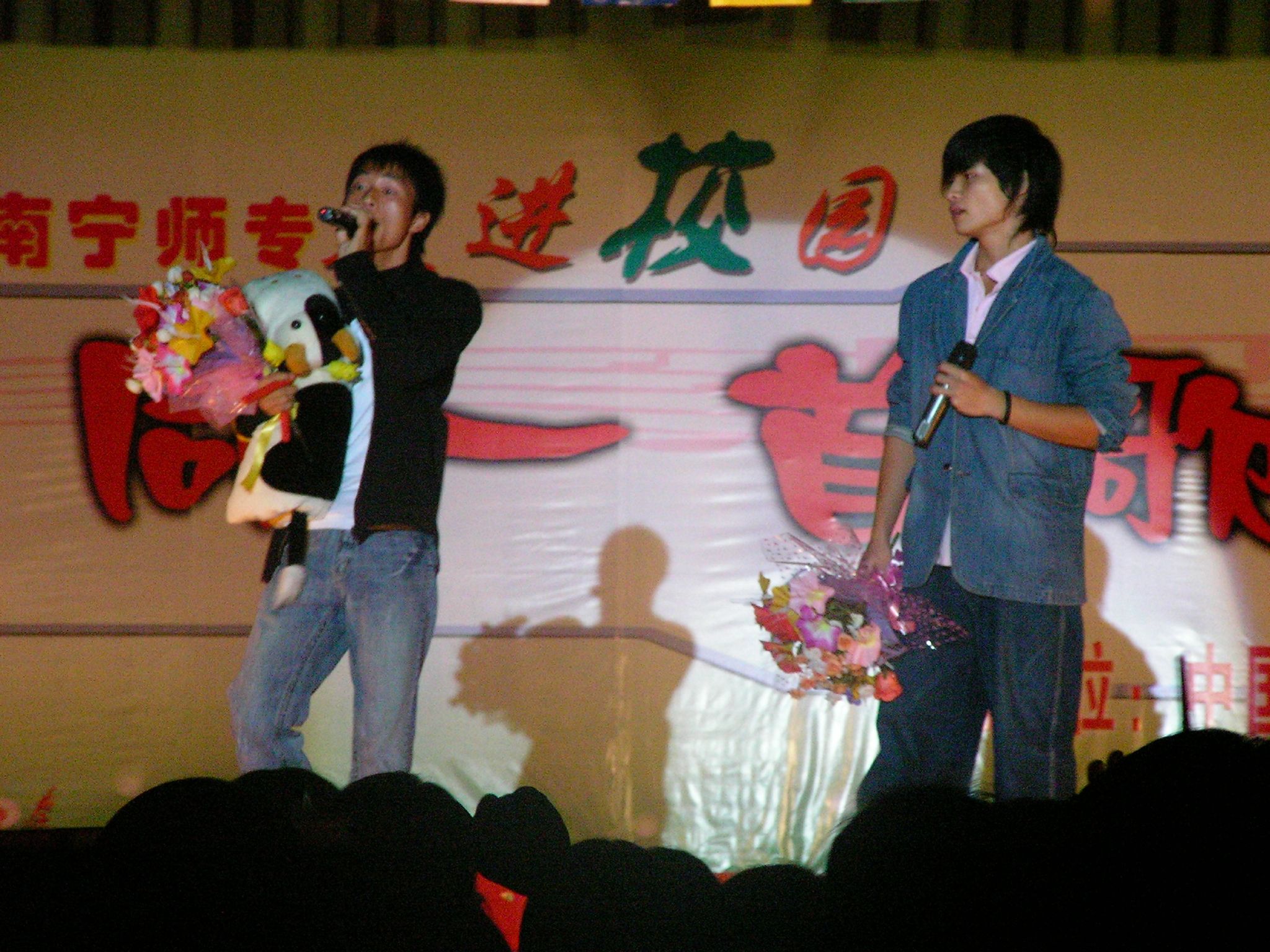 there are two men standing up on the stage
