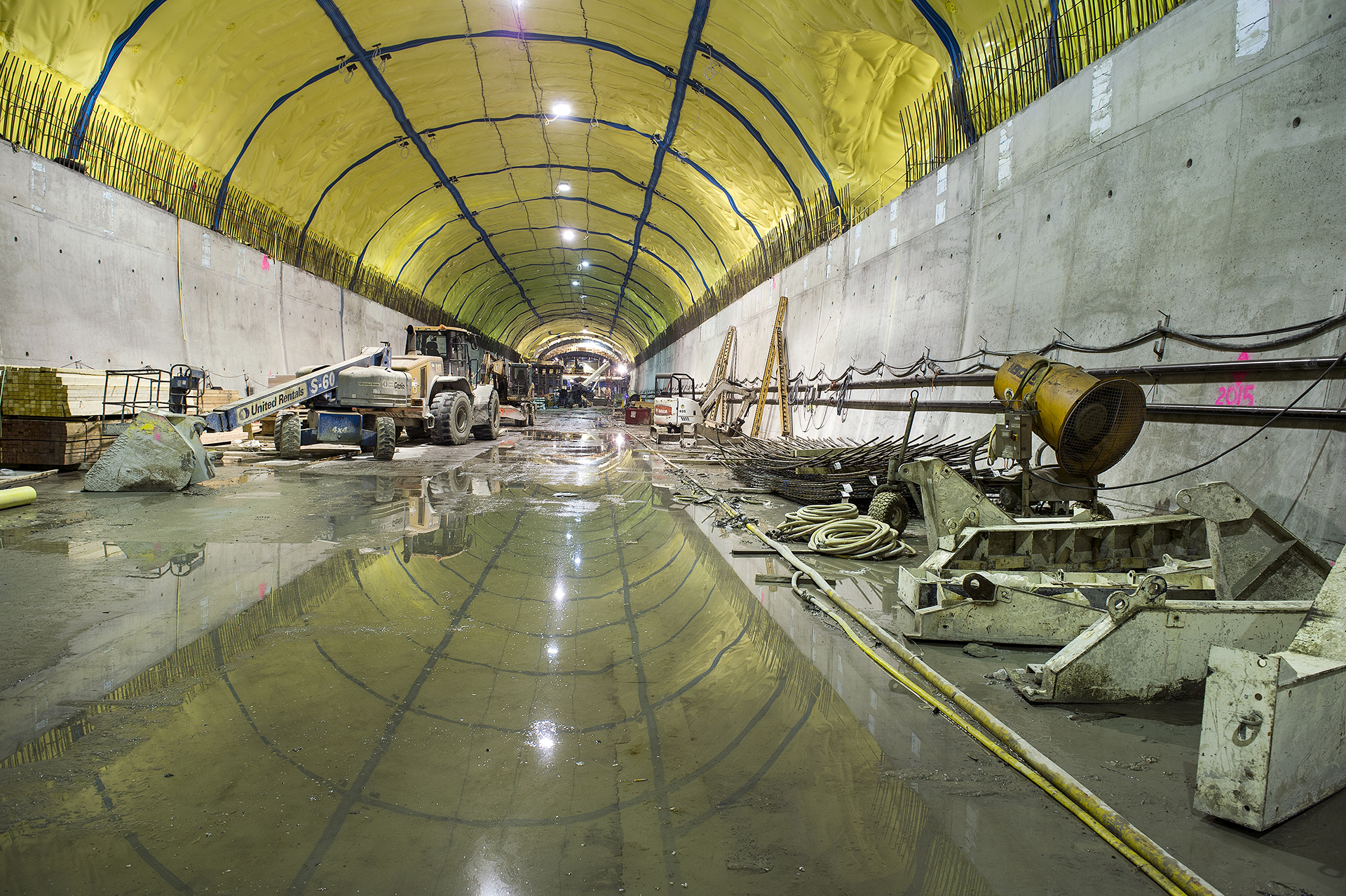 an empty and messy subway station with workers working