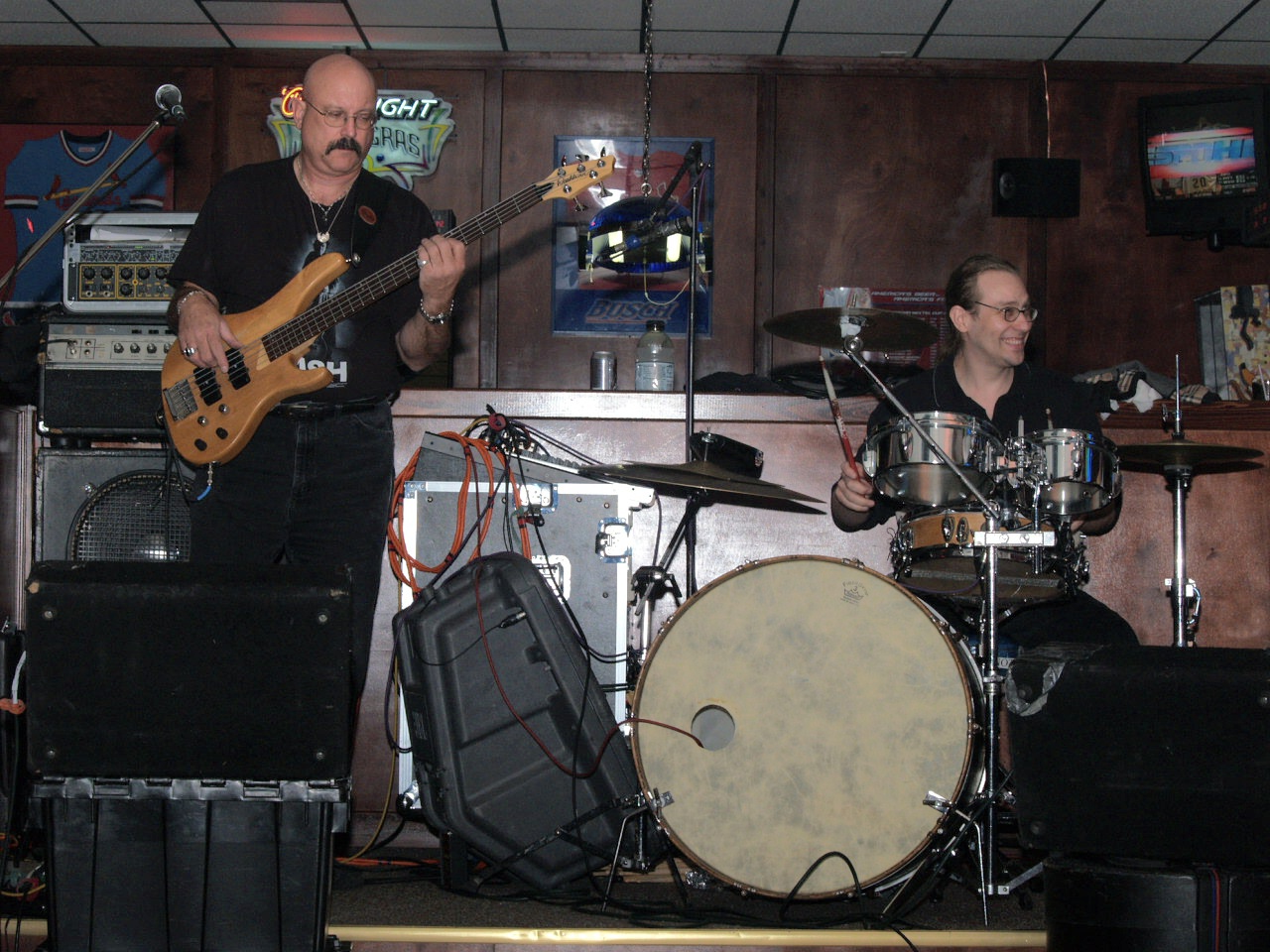 a band with instruments and a man with a beard plays