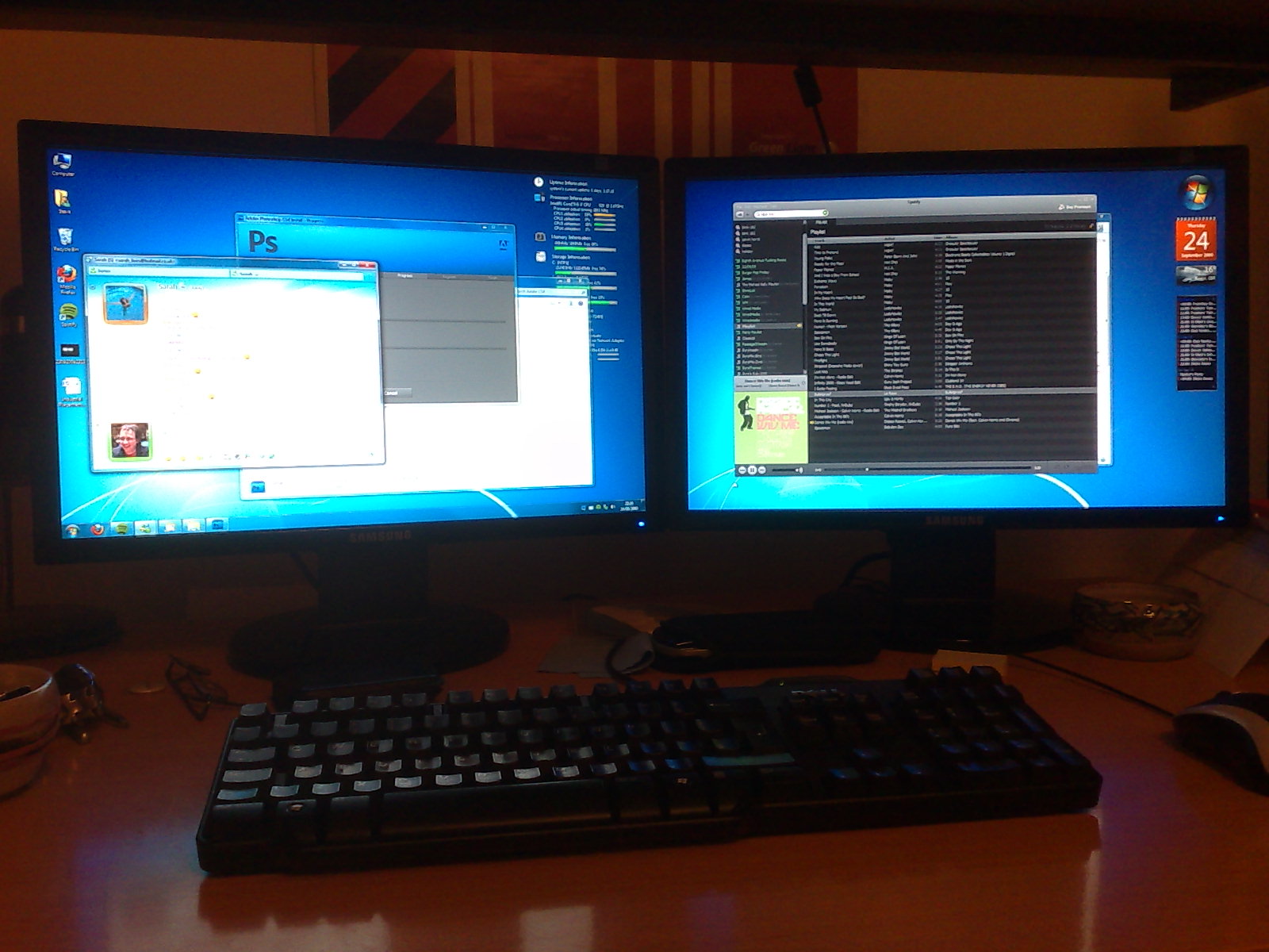 two computers with screens and keyboards on a desk