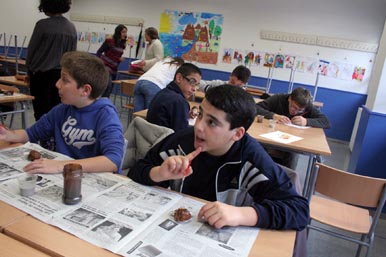 the students are sitting at desks and eating