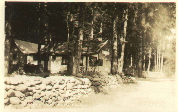 an old black and white po of a house surrounded by trees
