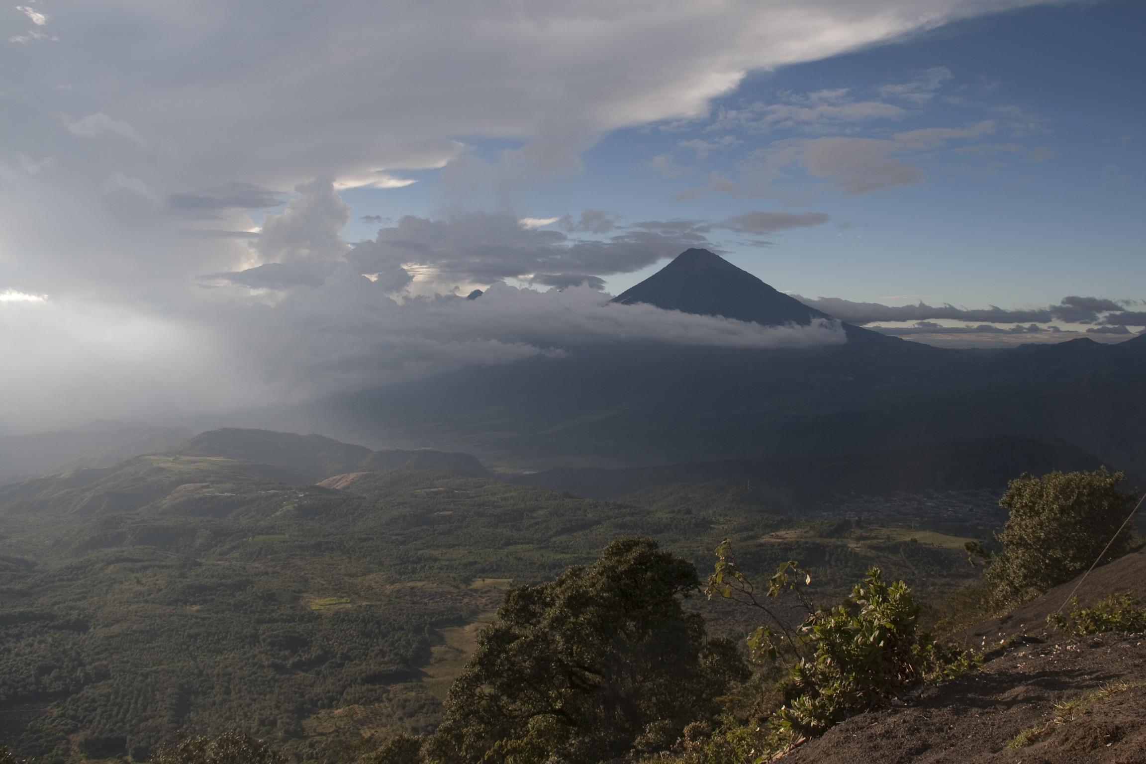 mountains and clouds are in view over a valley