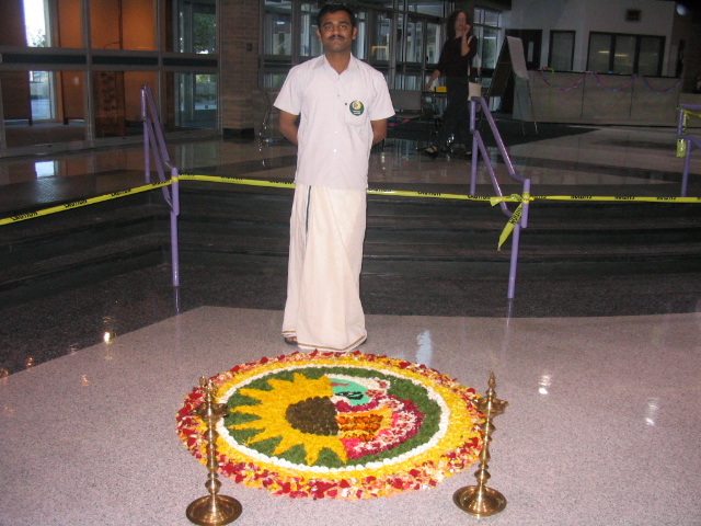 a man stands beside a decorated decorative item