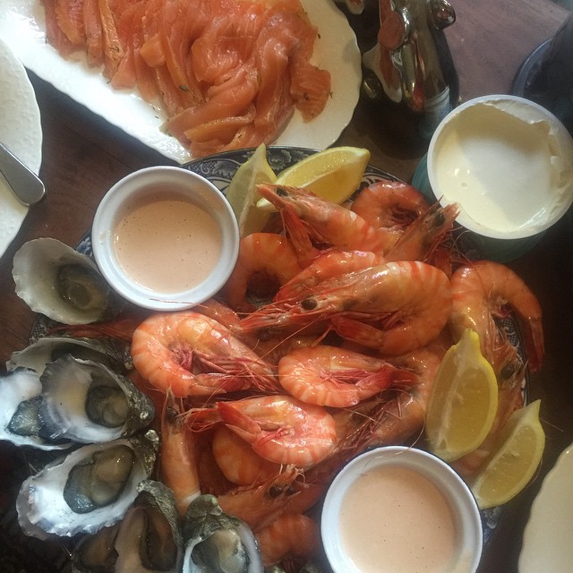 a big platter of seafood is next to a plate