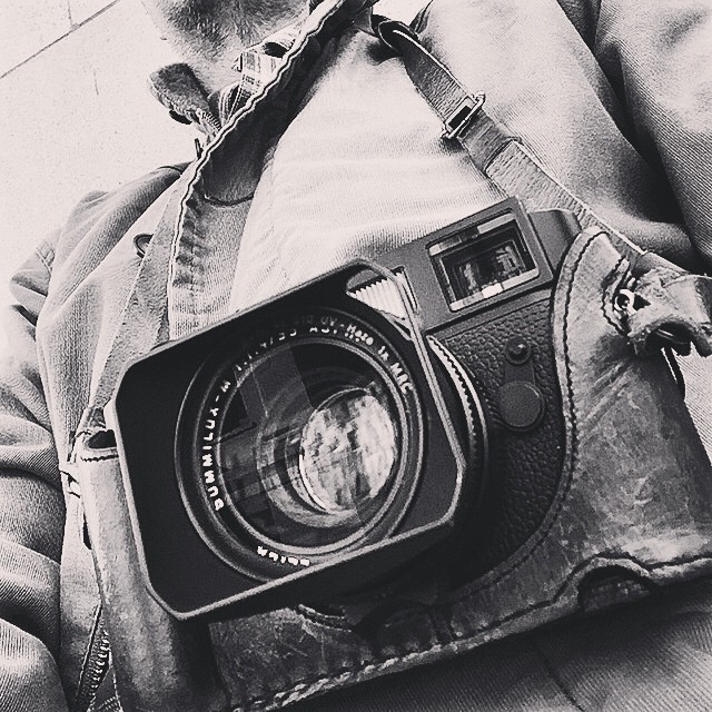 a person is holding an old camera in their hand