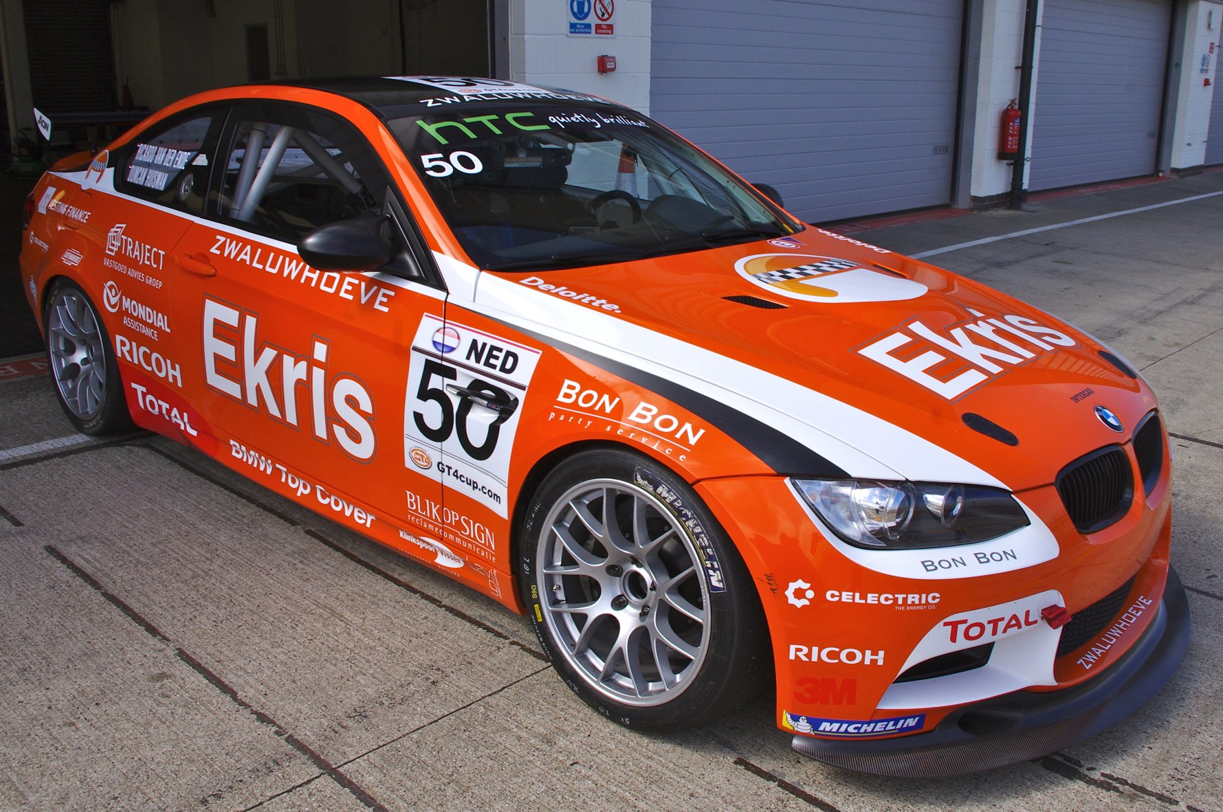 an orange sports car is parked on the street