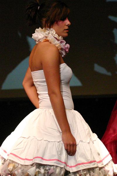 a woman in white dress and a pink bow on top of her head