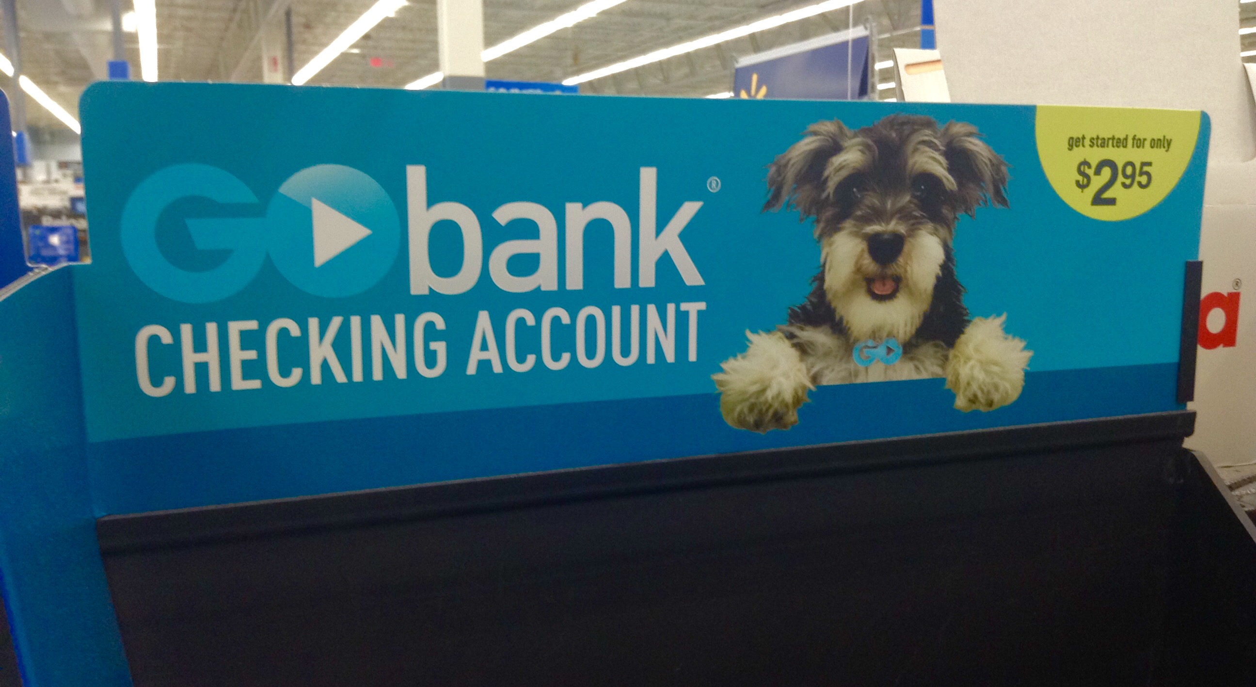 a sign advertising a dog sitting on the counter of a bank
