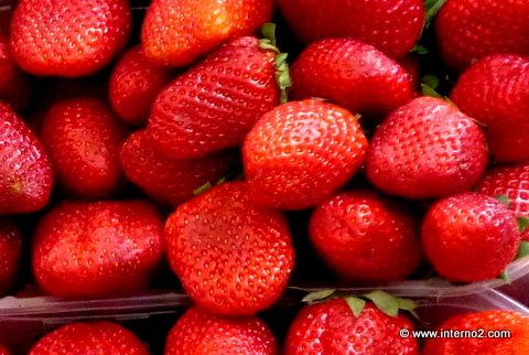a pile of freshly picked strawberries are displayed