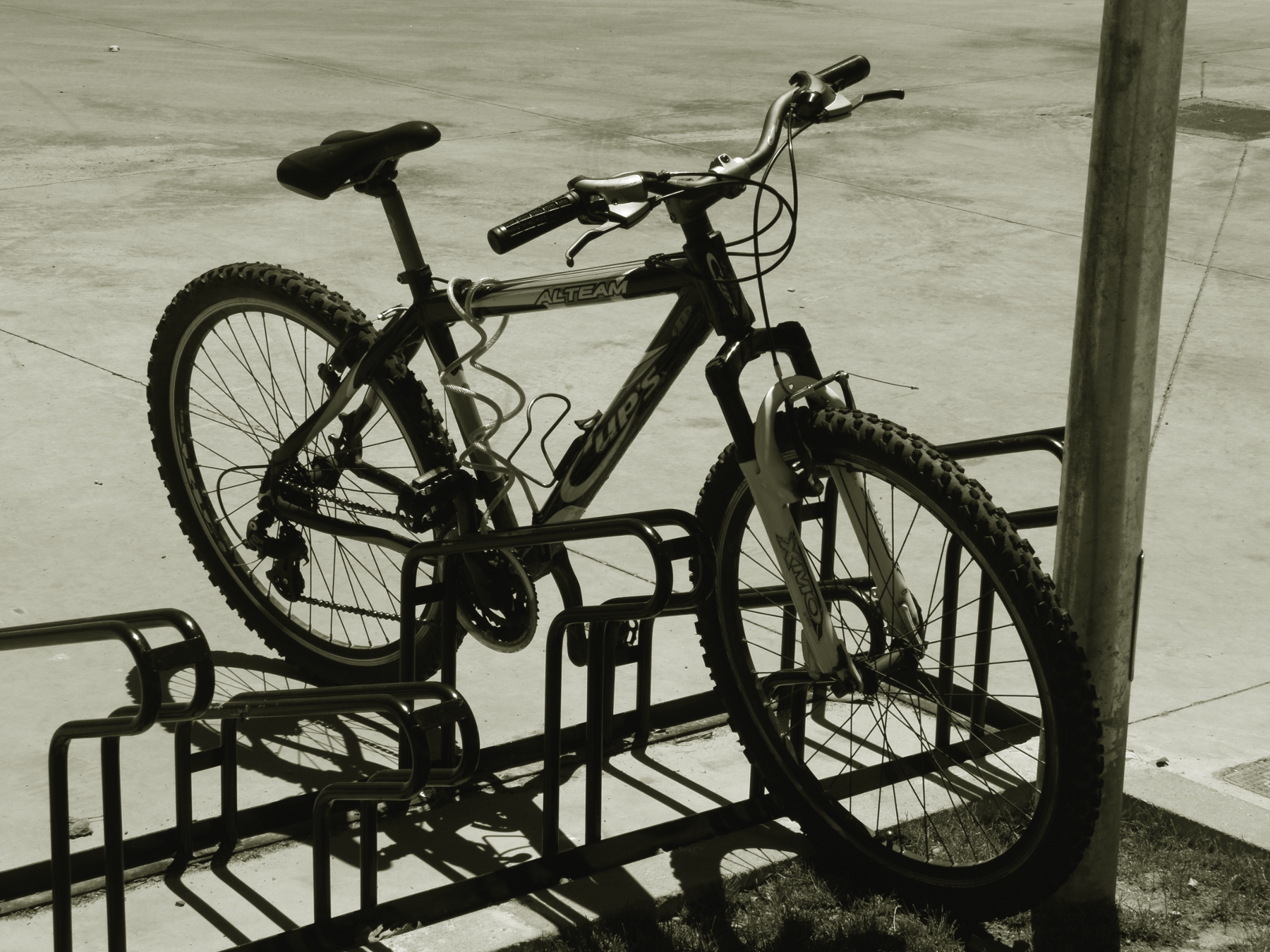 a bicycle is secured on the side of the pole