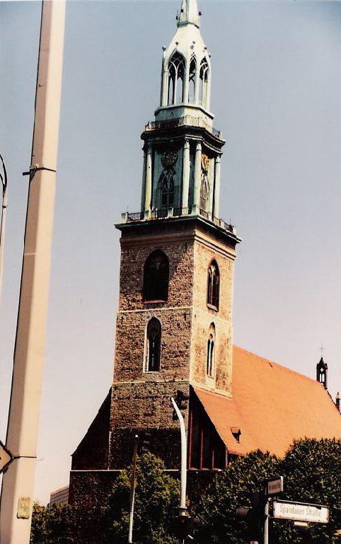 the spire is made of red brick and grey stone